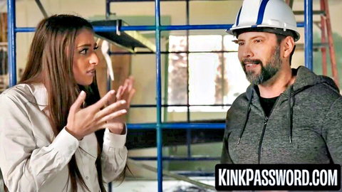 Brunette babe in blouse gestures emphatically to bearded man in hard hat on construction set