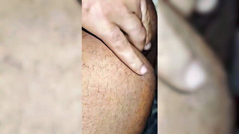 Blurry close-up of hand caressing hairy male thigh in Arab threesome