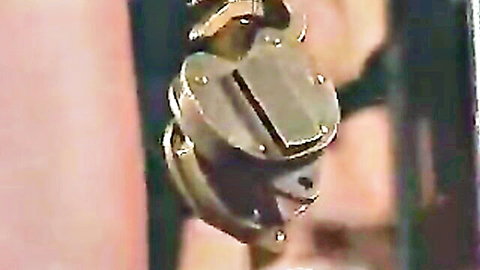 Shiny gold padlock hanging open for BDSM bondage and slave restraint