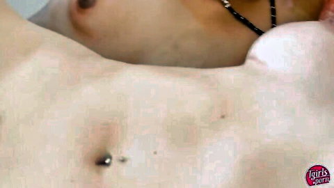 Close-up of pale trans gurl's pierced nipple and bare perky tits with necklace