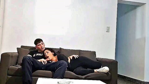 Skinny Latina woman giving blowjob to man on couch