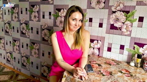 Skinny blonde Russian wife in tight pink dress showing cleavage at kitchen table amateur tease