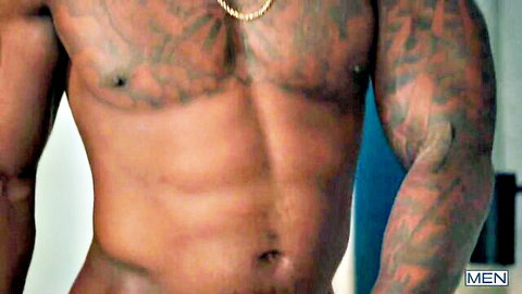 Tattooed muscular black stud shows ripped abs and chest in Men studio scene with Joey Mills