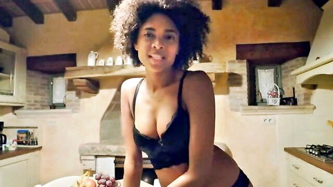 Hot ebony babe with funky afro in black lingerie posing seductively