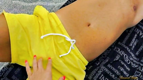 Sensual Jane's hand teases Sandy Beach's bulge in yellow shorts on sunny beach