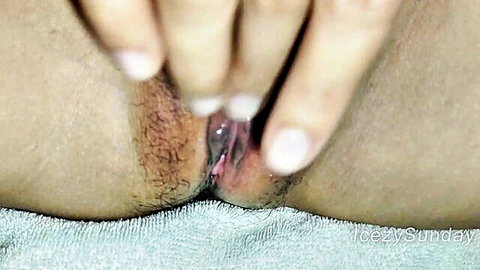 Asian woman spreads her hairy wet pussy lips wide with fingers in extreme closeup POV