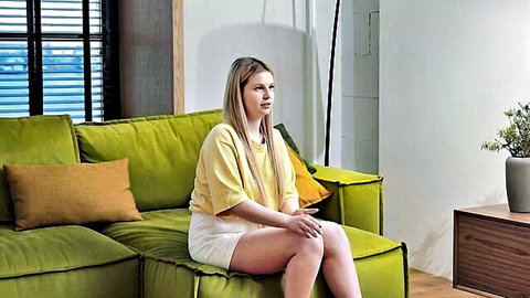 Blonde Liza Virgin lounging in yellow top and shorts