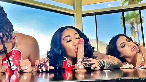 Three ebony beauties sharing a massive dildo blowjob outdoors