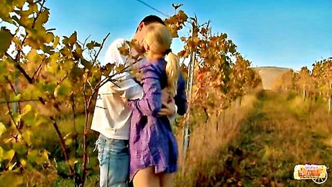 Marry Queen kissed passionately from behind by lover in vineyard, outdoor couple embrace