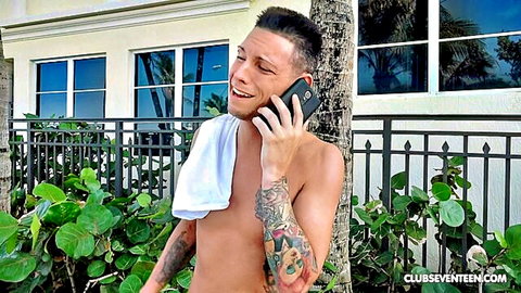 Tyler Steel shirtless in towel, smiling on phone outdoors with Hailey Little