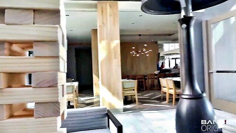 Blonde girl in modern restaurant setting swallows massive load