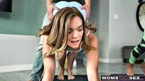 Blonde MILF in white tank top on all fours yoga pose with man behind, stepmom seduction scene
