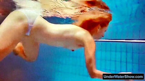 Redhead swims underwater topless flashing perky tits and white thong ass in pool