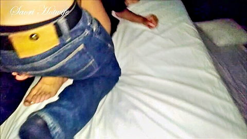 Hot wife in tight jeans with unbuckled belt on bed, intimate scene
