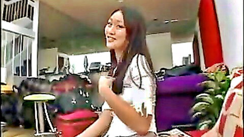 Evelyn Lin smiling seductively in white fringe top