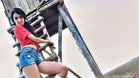 Sexy Czech brunette teen teasing in tiny denim shorts and crop top by outdoor wooden tower