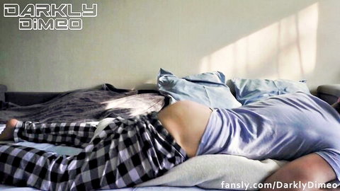 Slim guy lying face down on bed with checkered pants down exposing bare ass cheeks.