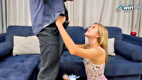 Blonde babe kneels on floor grabbing man's crotch bulge pulling down pants on couch