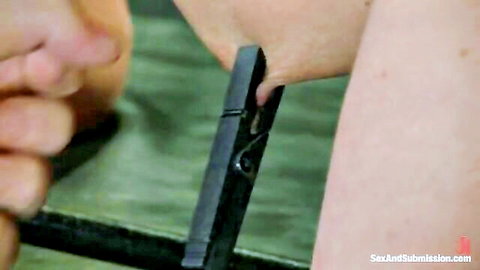 Blonde babe's arm clamped with clothespin in BDSM submission