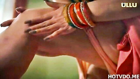 Desi girl in pink dress with bangles, leg raised in intimate Ullu web series scene