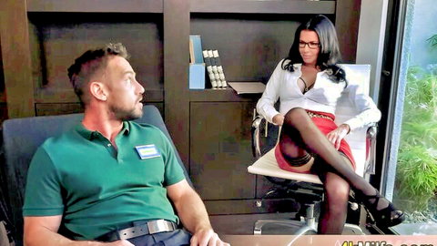 Seductive brunette MILF therapist in stockings and glasses teases with big tits and crossed legs in office