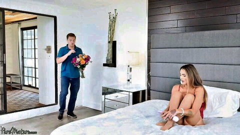 Surprised man with flowers surprises seductive blonde stepmom in red lingerie on bed
