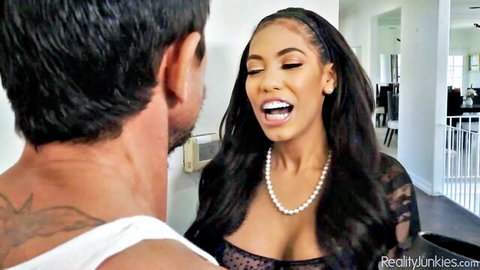 Gia Milana in lace top smiles seductively at muscular man in intimate moment