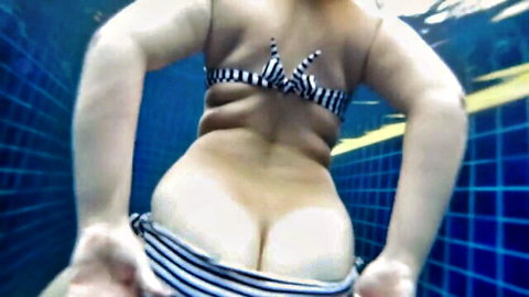 Underwater PAWG in striped bikini showing tight ass in pool after party