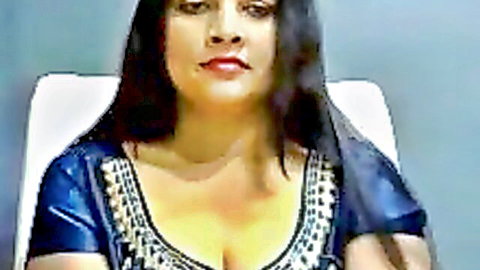 Sexy Indian webcam babe with big tits showing deep cleavage in shiny blue embroidered top