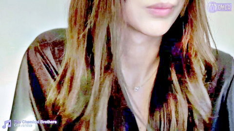 Young busty redhead webcam tease puckers glossy lips showing deep cleavage in shiny top