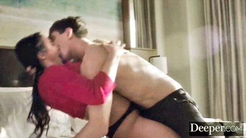 Angela White voluptuously embracing and kissing muscular stud in passionate bed scene
