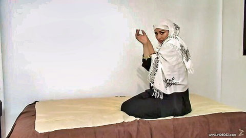 Arab MILF in hijab sitting on bed, showcasing big ass from behind
