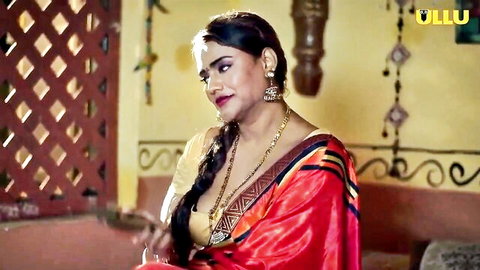 Seductive Indian woman in red saree with deep cleavage and jewelry
