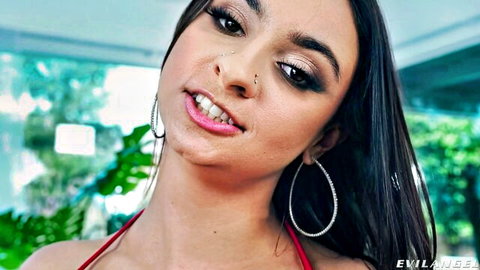 Seductive brunette teen smiling closeup with glossy lips hoop earrings red bikini top