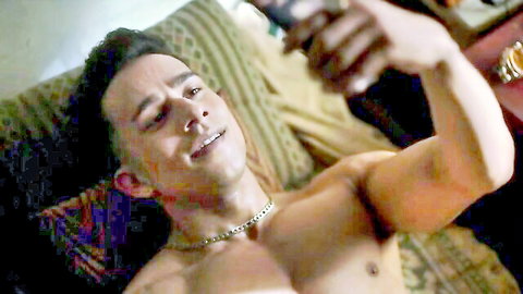 Shirtless muscular Indian man lounging and taking selfie