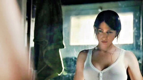 Brunette with medium tits in wet white tank top showing deep cleavage in steamy bathroom mirror scene
