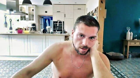 Muscular shirtless hunk leaning chin on hand in kitchen webcam solo tease