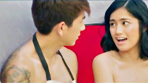 Topless Filipina beauty with bare tits smiles surprised at shirtless tattooed Asian hunk in intimate scene