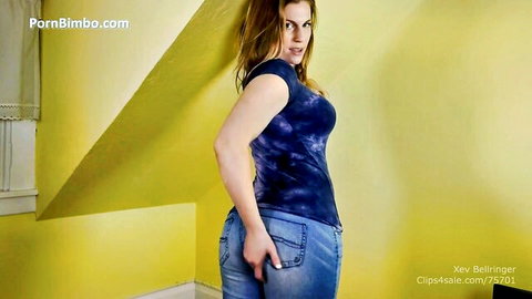 Curvy brunette babe grabs her big juicy ass in tight jeans teasing seductively from behind