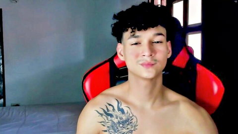 Shirtless Morthy Downey with dragon tattoo, curly hair, playful smile