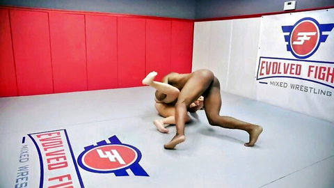 Red August nude in intense mixed wrestling grapple on mat