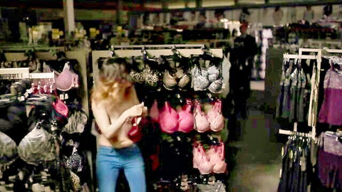 Emily Hampshire topless in lingerie store, holding pink bra