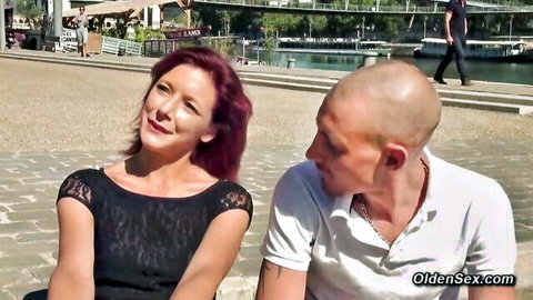 Redhead MILF in black lace top flirts with bald guy outdoors by river