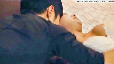 Korean couple in intimate neck kiss embrace on bed, swinger swapping scene