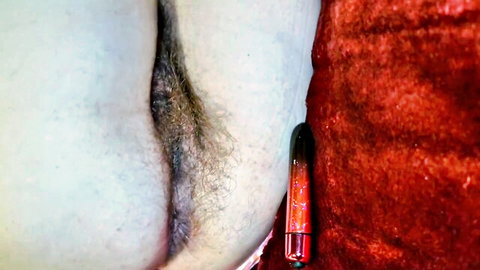 HairyErotica's hairy pussy vibrates with red toy inserted closeup