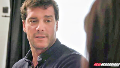 Handsome brunette DILF smiling seductively in dark shirt closeup