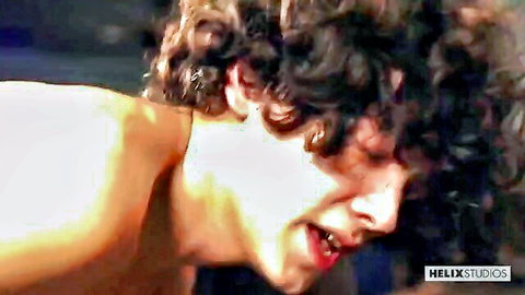 Close-up of curly-haired twink's moaning face with open mouth during blowjob pleasure