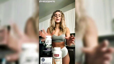 Abby in grey sports bra and white panties posing seductively in kitchen