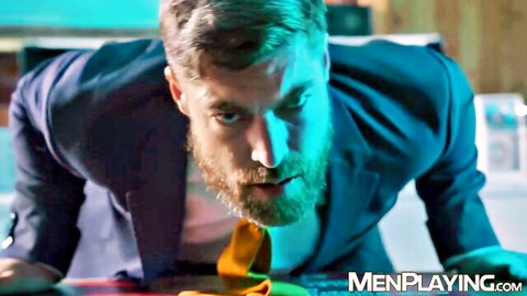 Teddy Torres in intense blue suit lean for Men At Play gay scene