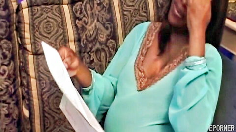 Smiling pregnant ebony MILF in teal lace dress holding paper, barefoot tease